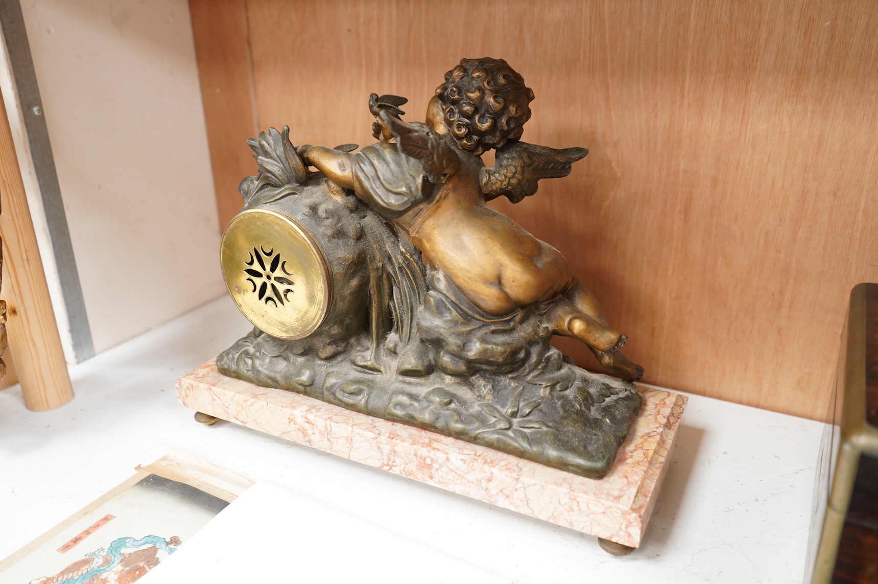 After Georges Maxim (French, 1885-1940), ‘Le Charmeur’, an early 20th century gilt spelter and rouge marble mantel clock, 39cm wide